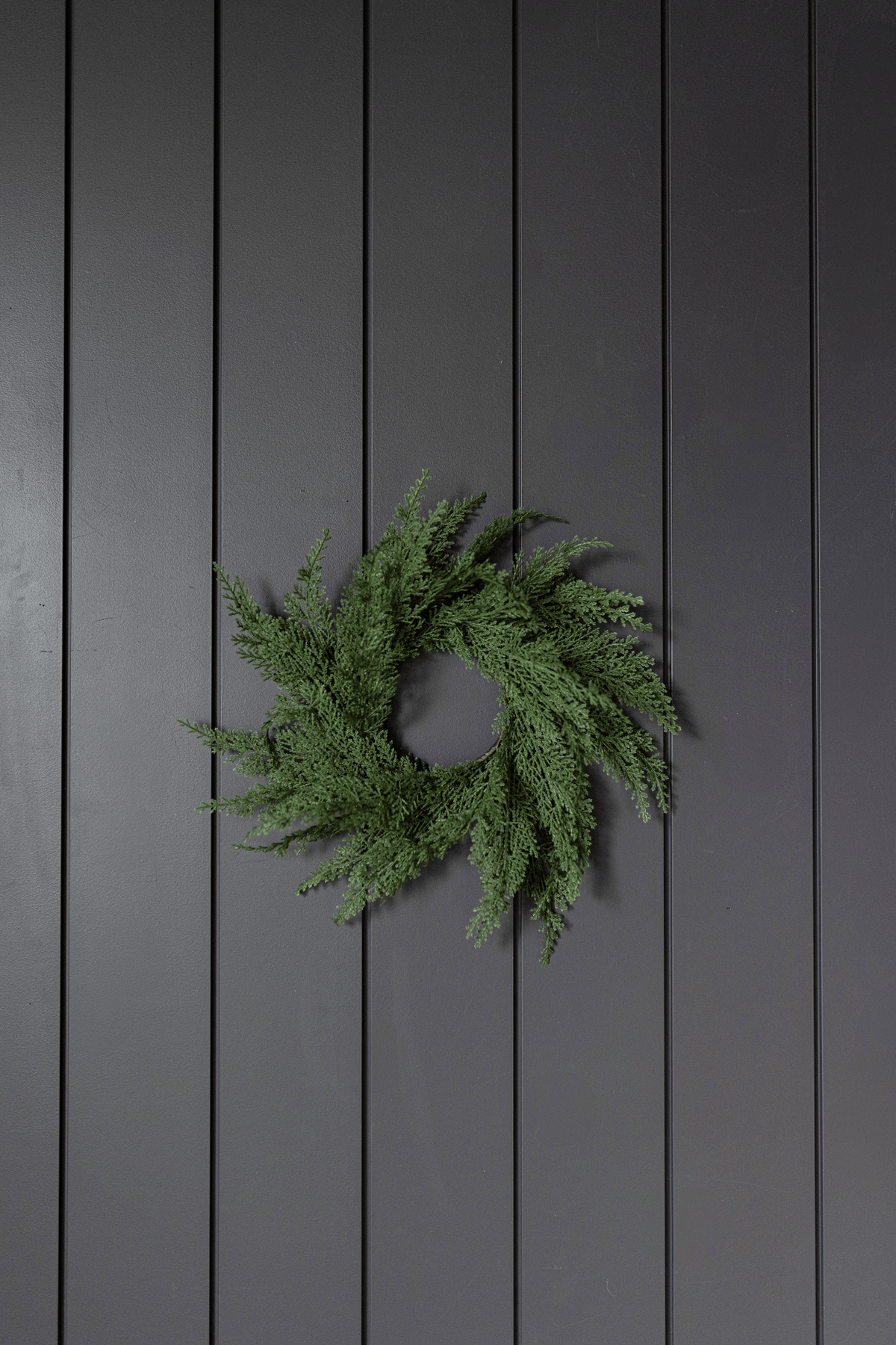 Green cypress leaf wreath with dense sprays and central circular opening