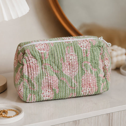 Green cosmetic pouch with repeating cat print, textured stripe fabric, and zip closure.