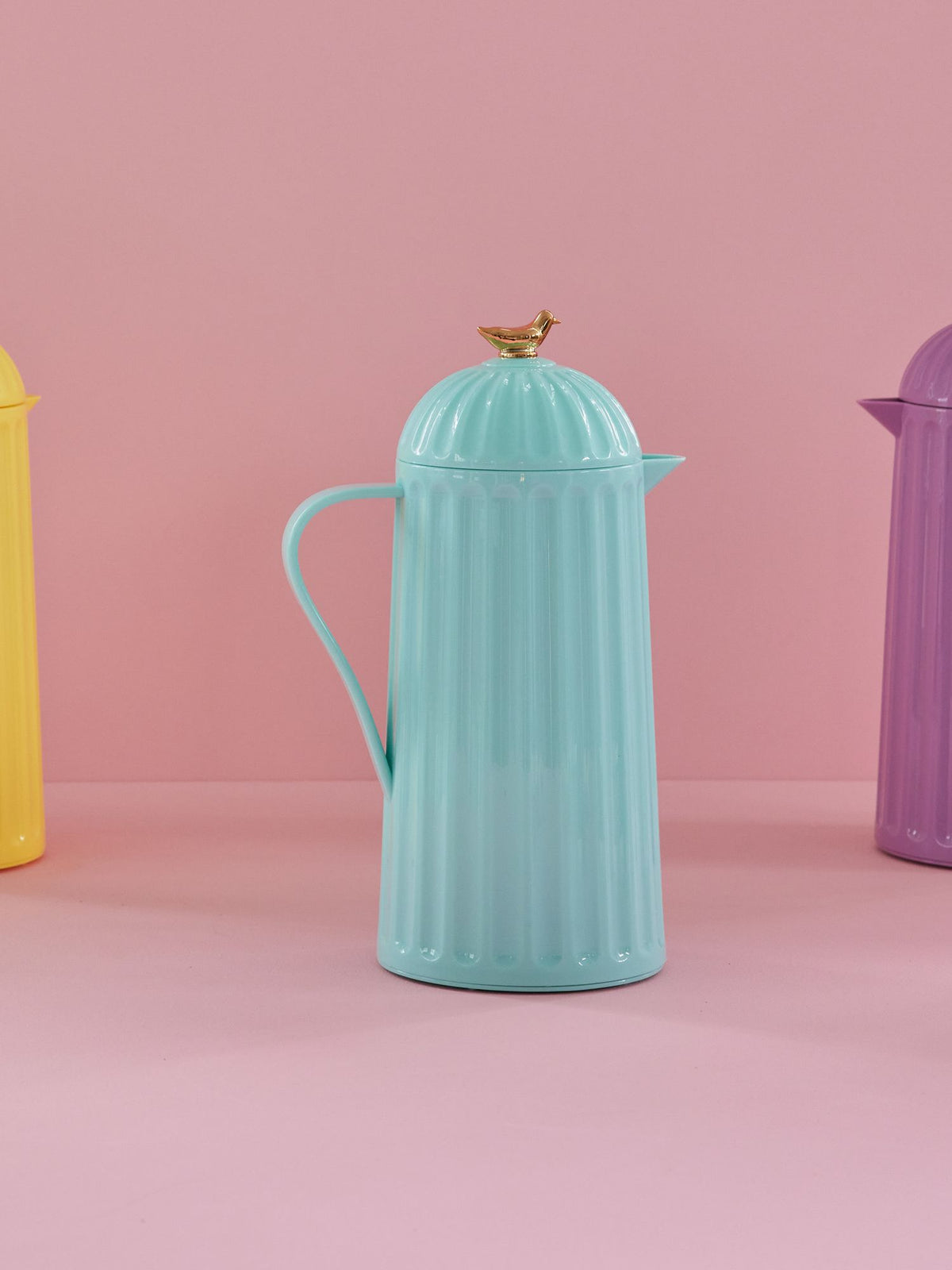 Mint green thermos pitcher with domed lid, curved spout, and carry handle
