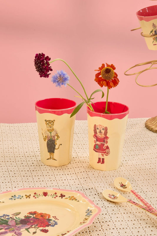 Two tall melamine cups, cream with red rims, featuring dog and cat artwork