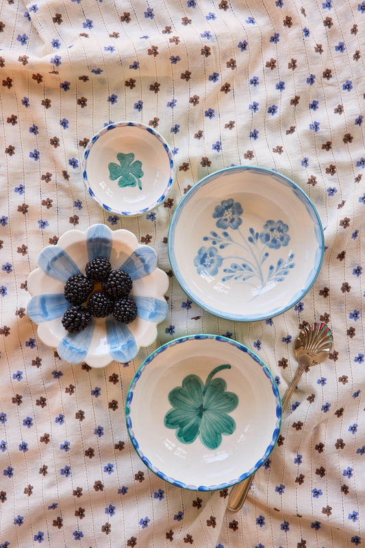 Ceramic dipping bowls with blue rims and green clover and leaf hand-painted motifs