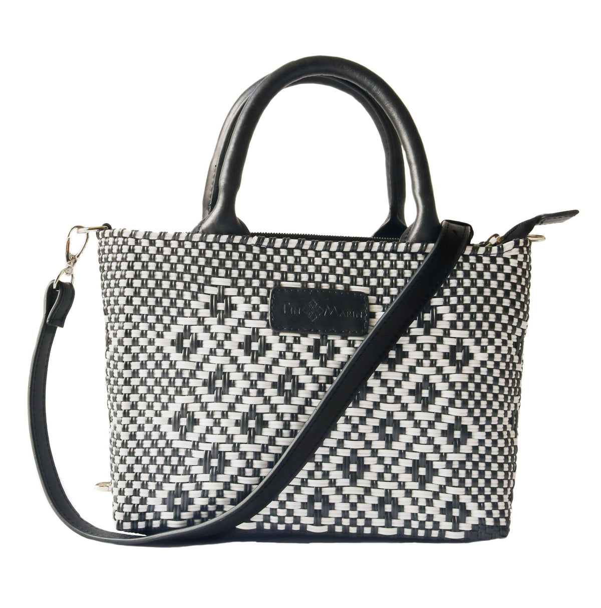 Small woven crossbody bag, black-and-white weave with black leather handles and crossbody strap.