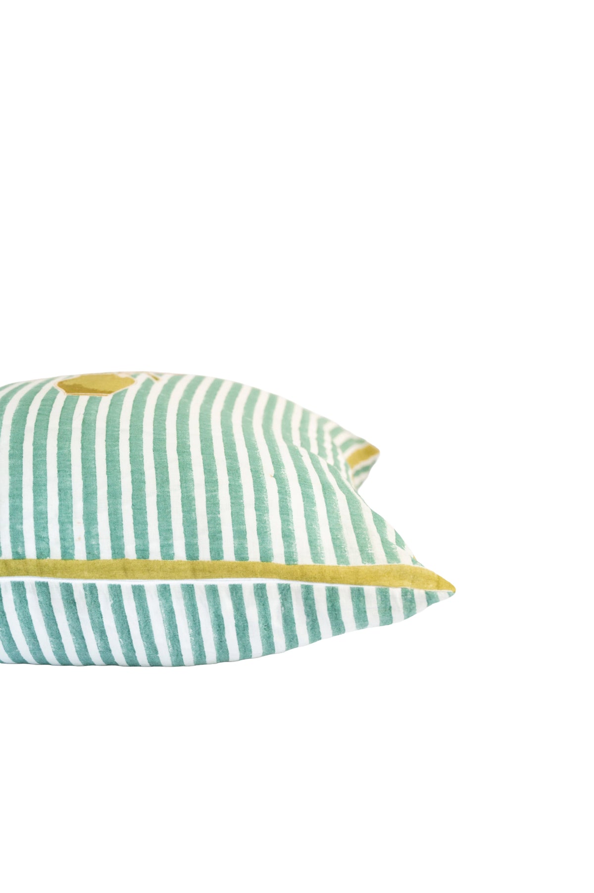 Angled close-up of green striped pillow showing yellow piping along the edge
