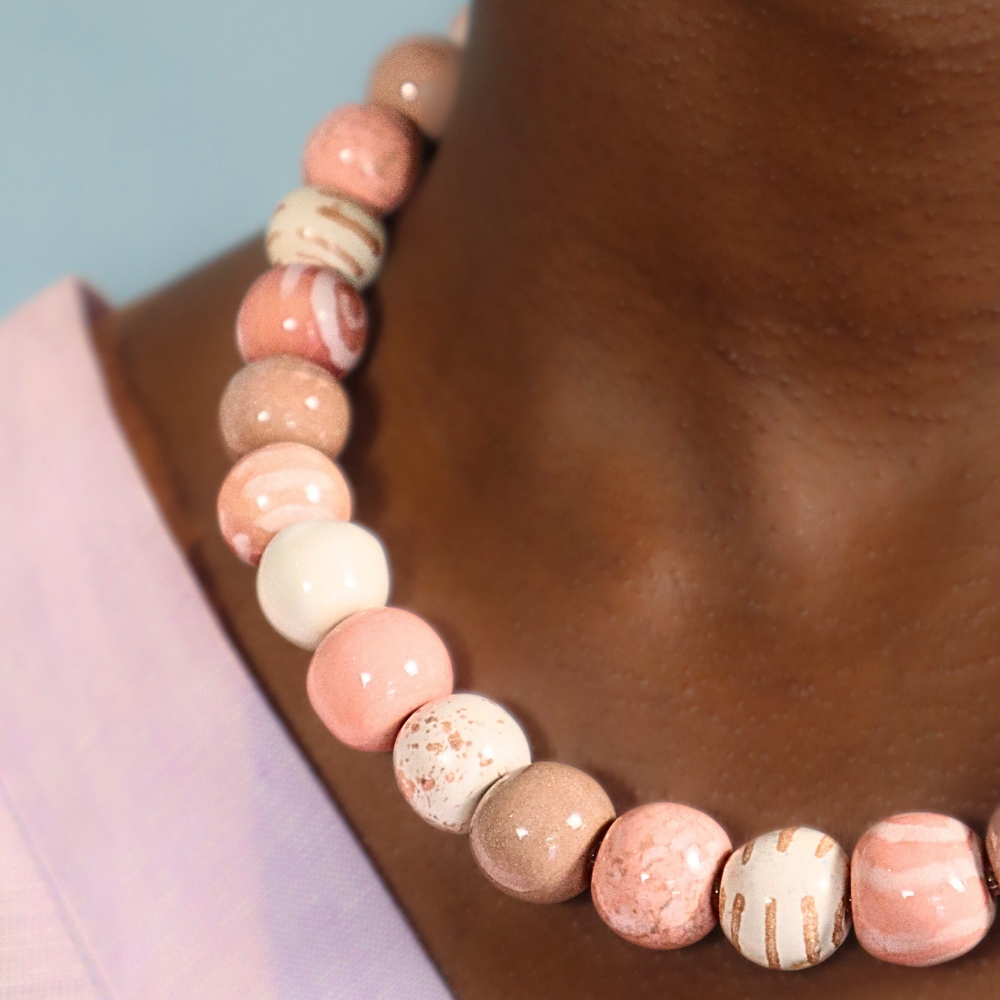 Pink and beige round beaded necklace with mixed speckled and striped beads
