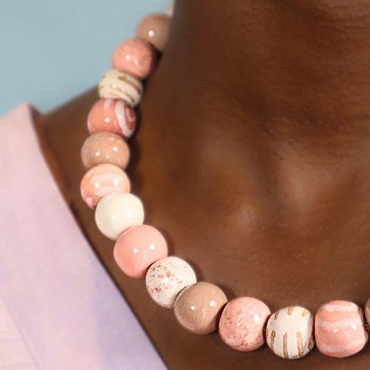Pink and beige round beaded necklace with mixed speckled and striped beads