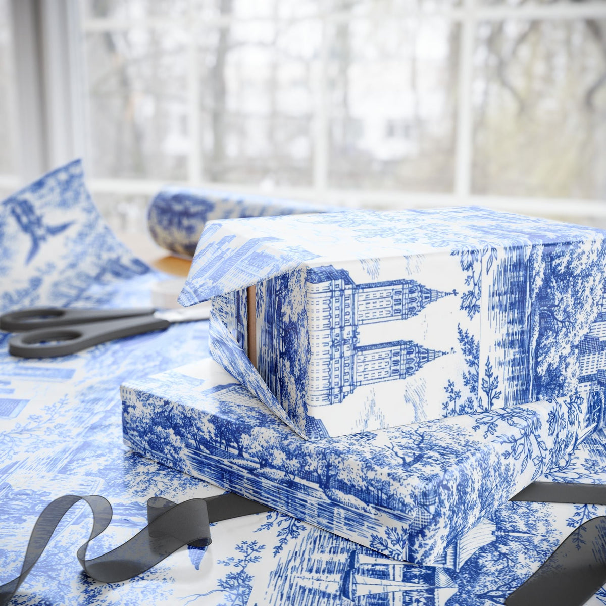 Blue-and-white toile wrapping paper gift boxes with black ribbon and bow