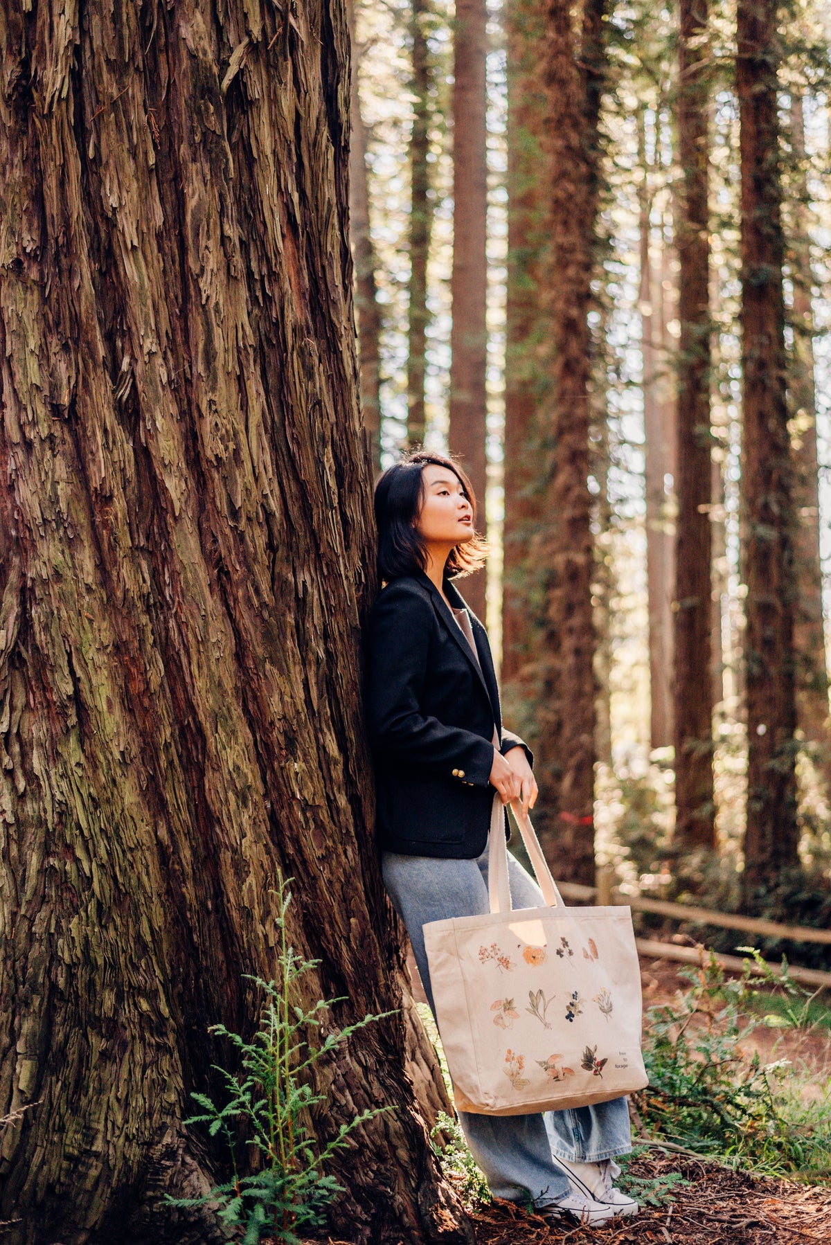 Canvas tote bag with botanical print, carried outdoors with long handles