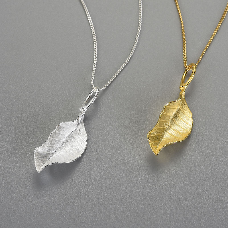 Silver and gold leaf pendant necklaces with curved hanging leaf charms