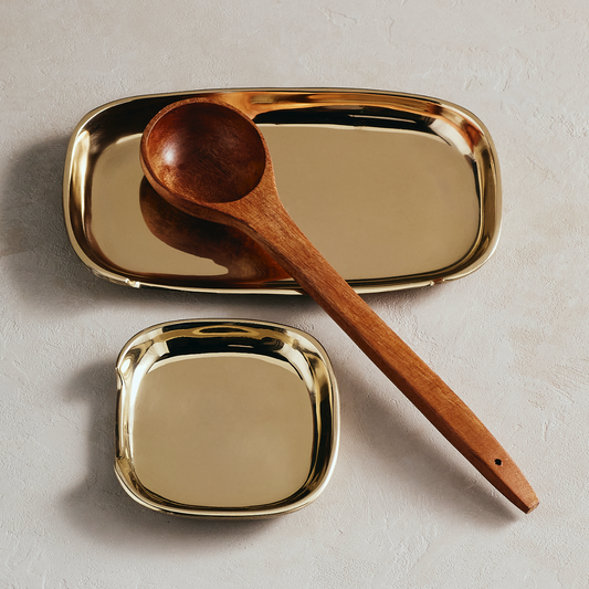 Aurum spoon rest with oval gold tray and brown wooden spoon