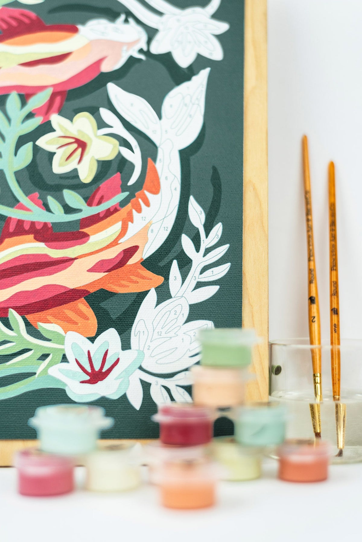 Koi pond canvas print with paintbrushes and small pots of paint