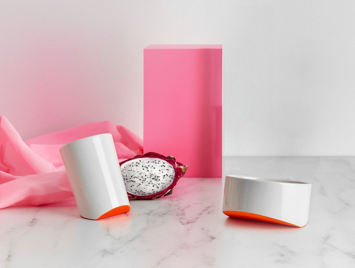 Ceramic cup and bowl set, white with orange underside accents