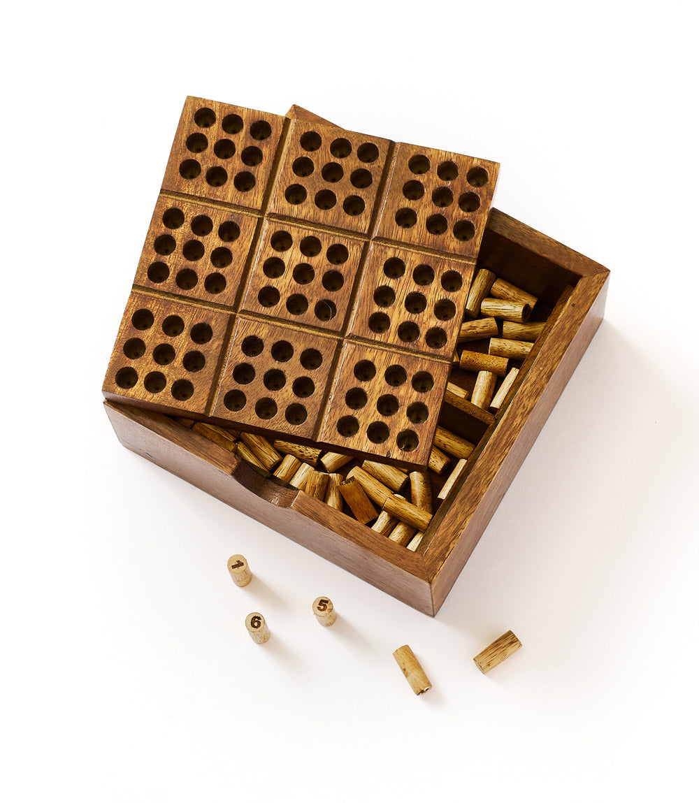 Hand-carved wooden peg puzzle game in open wooden box with perforated sliding boards