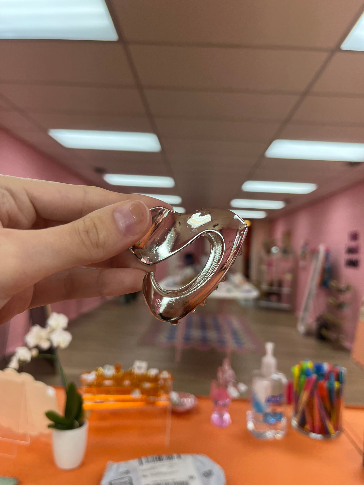 Oopsy Daisy hair claw, shiny silver-tone heart-shaped metal design.