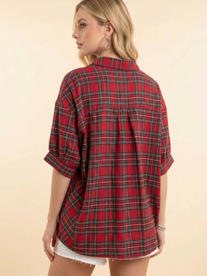 Back view of the red plaid shirt, showing its relaxed fit and short sleeves.