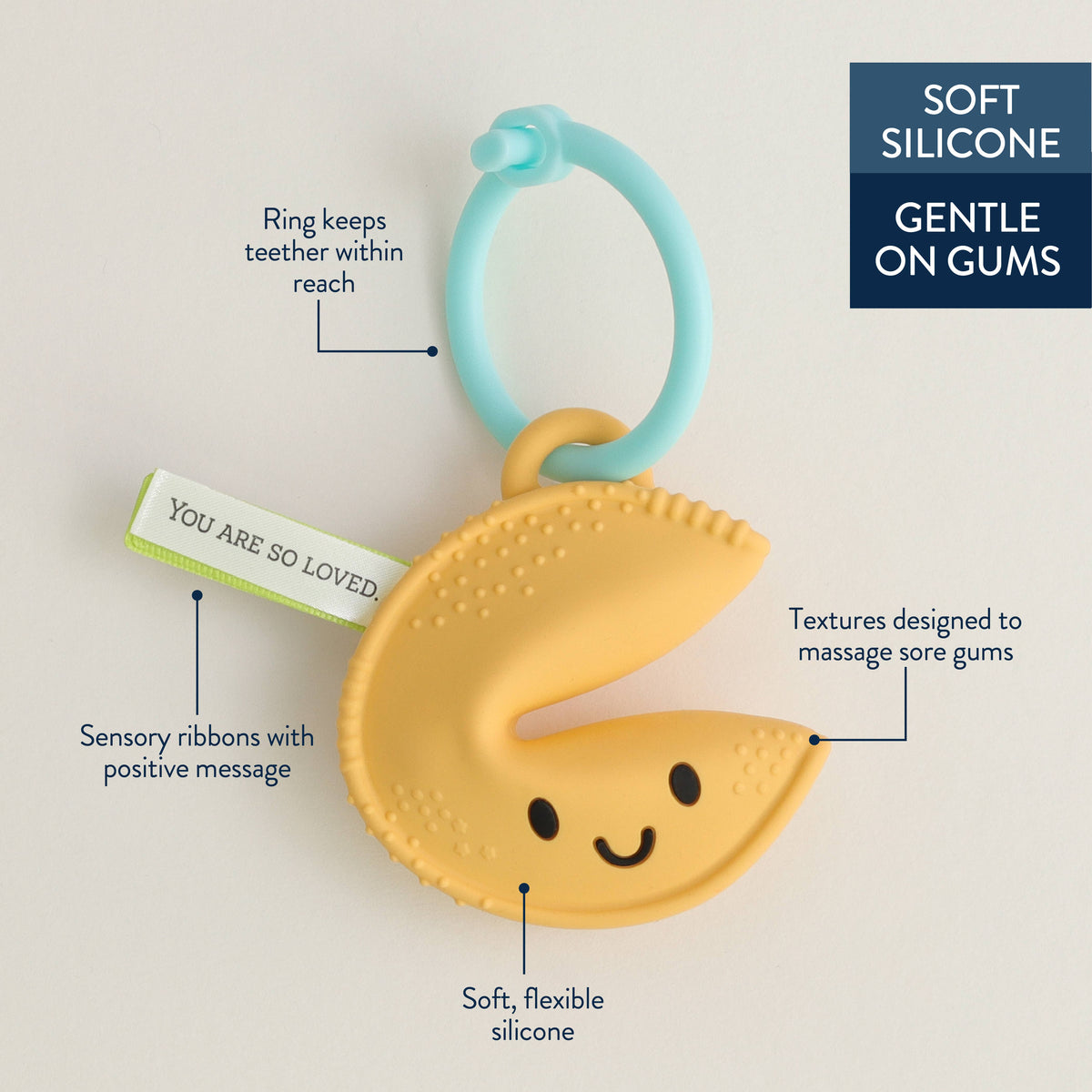 Fortune-cookie silicone teether with blue ring and green sensory ribbon