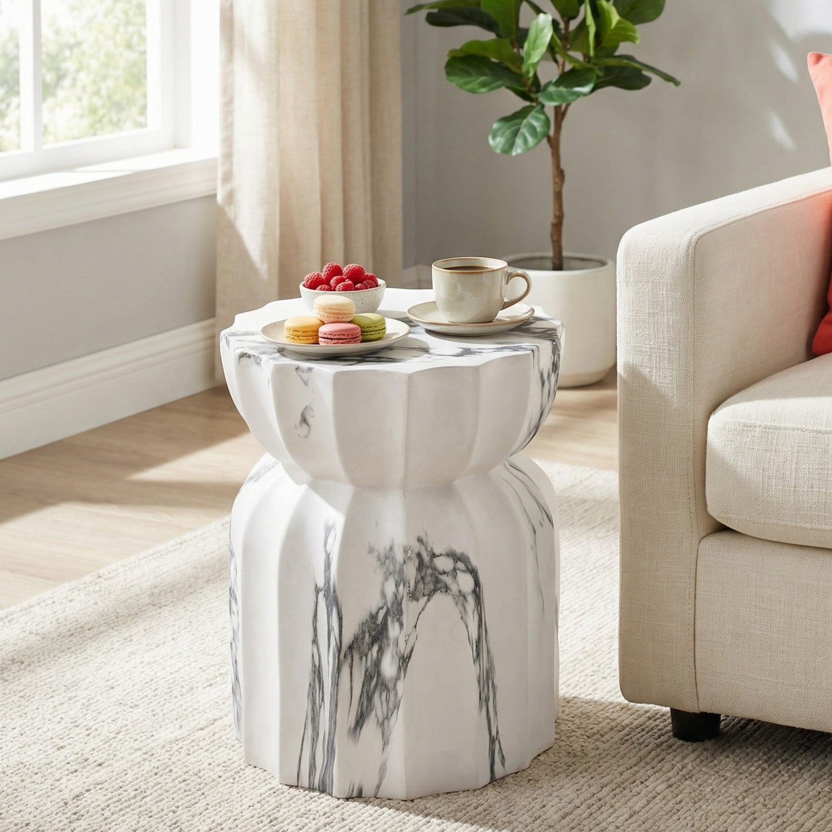 Marble-look side table with a sculpted hourglass pedestal and rounded top