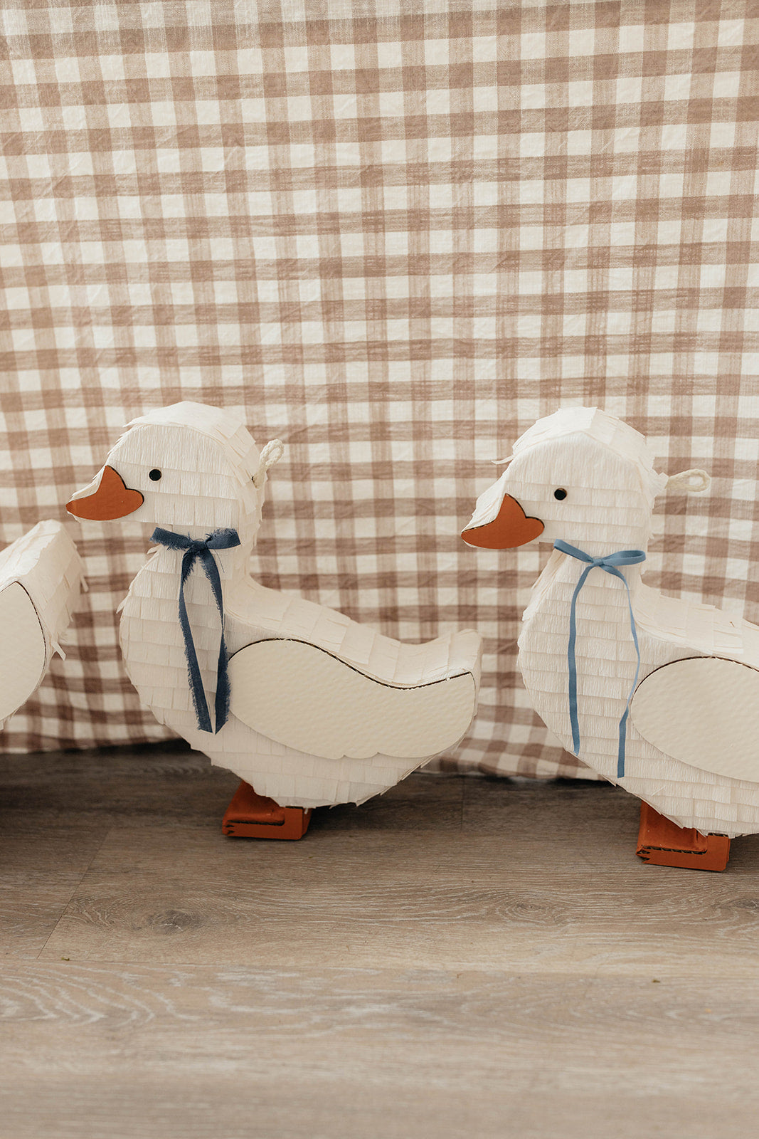 Duck piñata with blue ribbon and orange beak