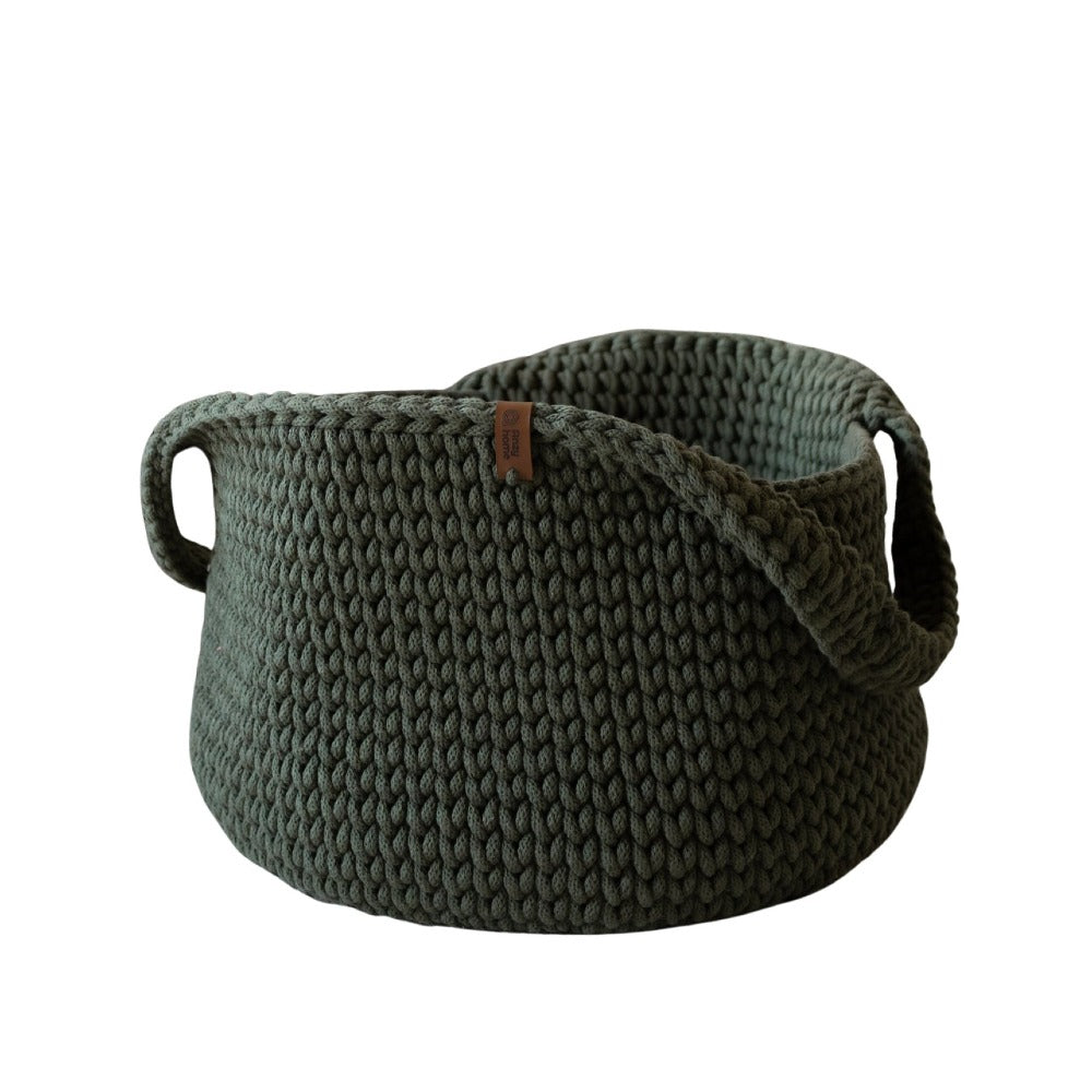 Dark green round knit basket with side handles, textured fabric and rolled edge.