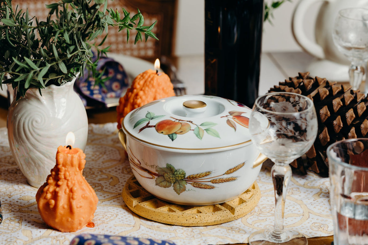 Marigold terrazzo round trivet with waffle diamond grid under a floral teapot