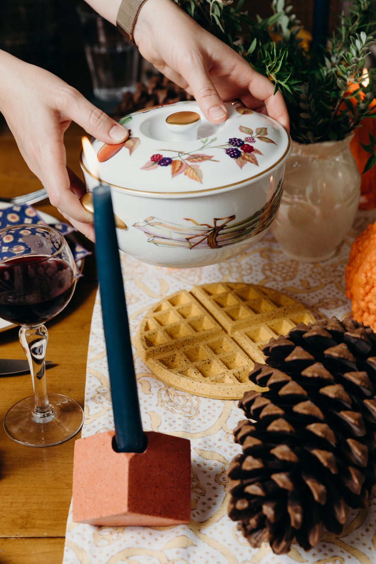 Waffle trivet in marigold terrazzo with diamond grid under a covered tea pot