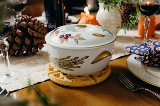 Marigold terrazzo waffle trivet supporting a white lidded teapot on a table