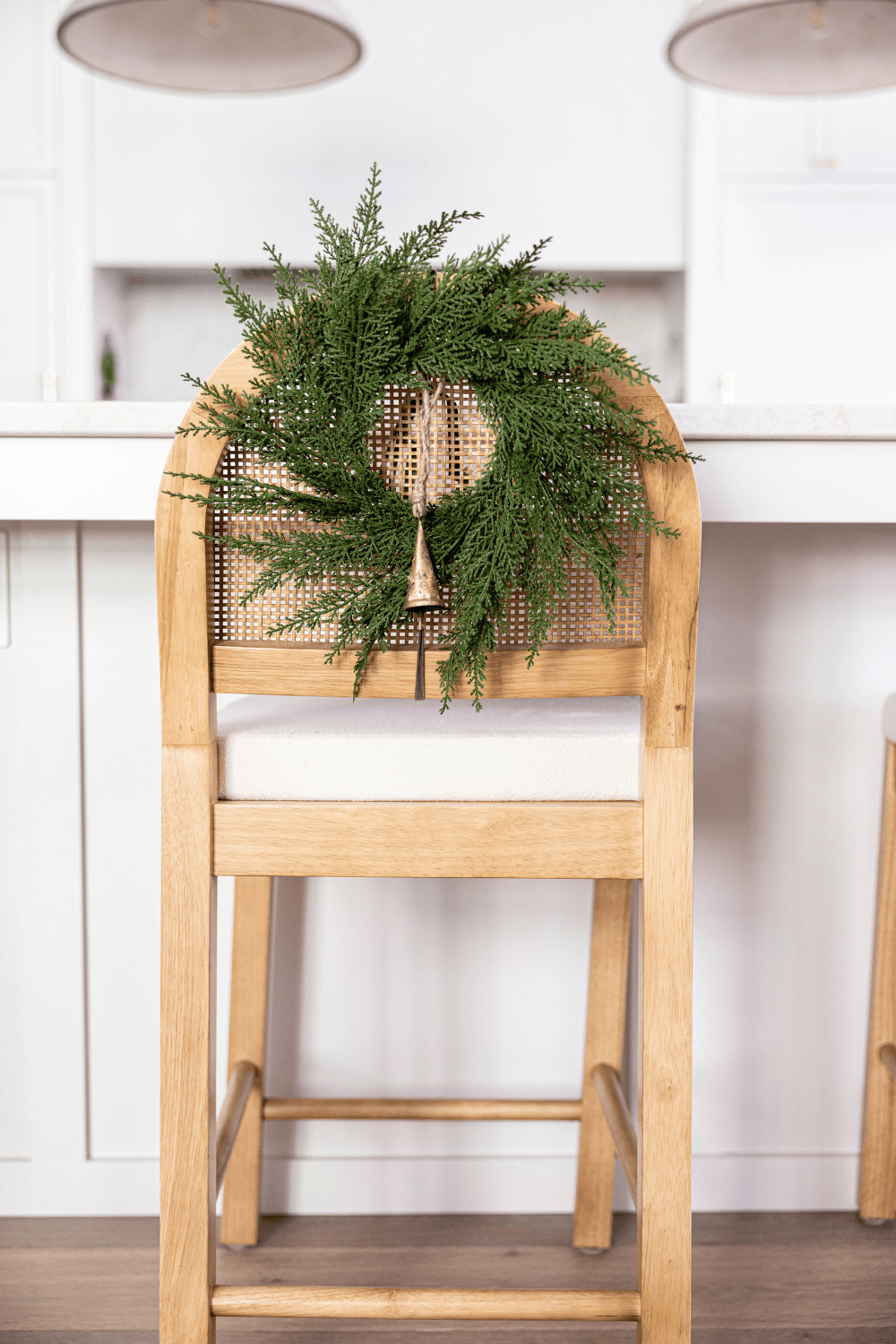 Green cypress leaf wreath with mesh backing and warm string lights