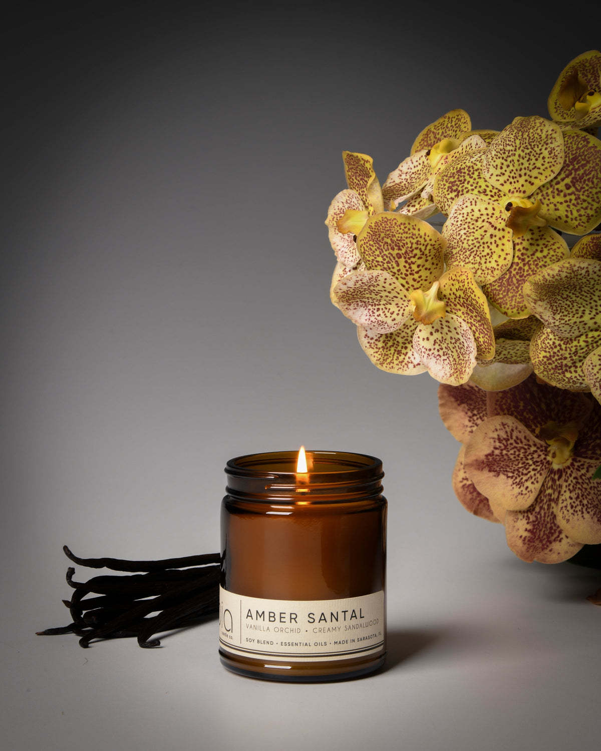 Amber glass soy candle jar with flame, small jar view