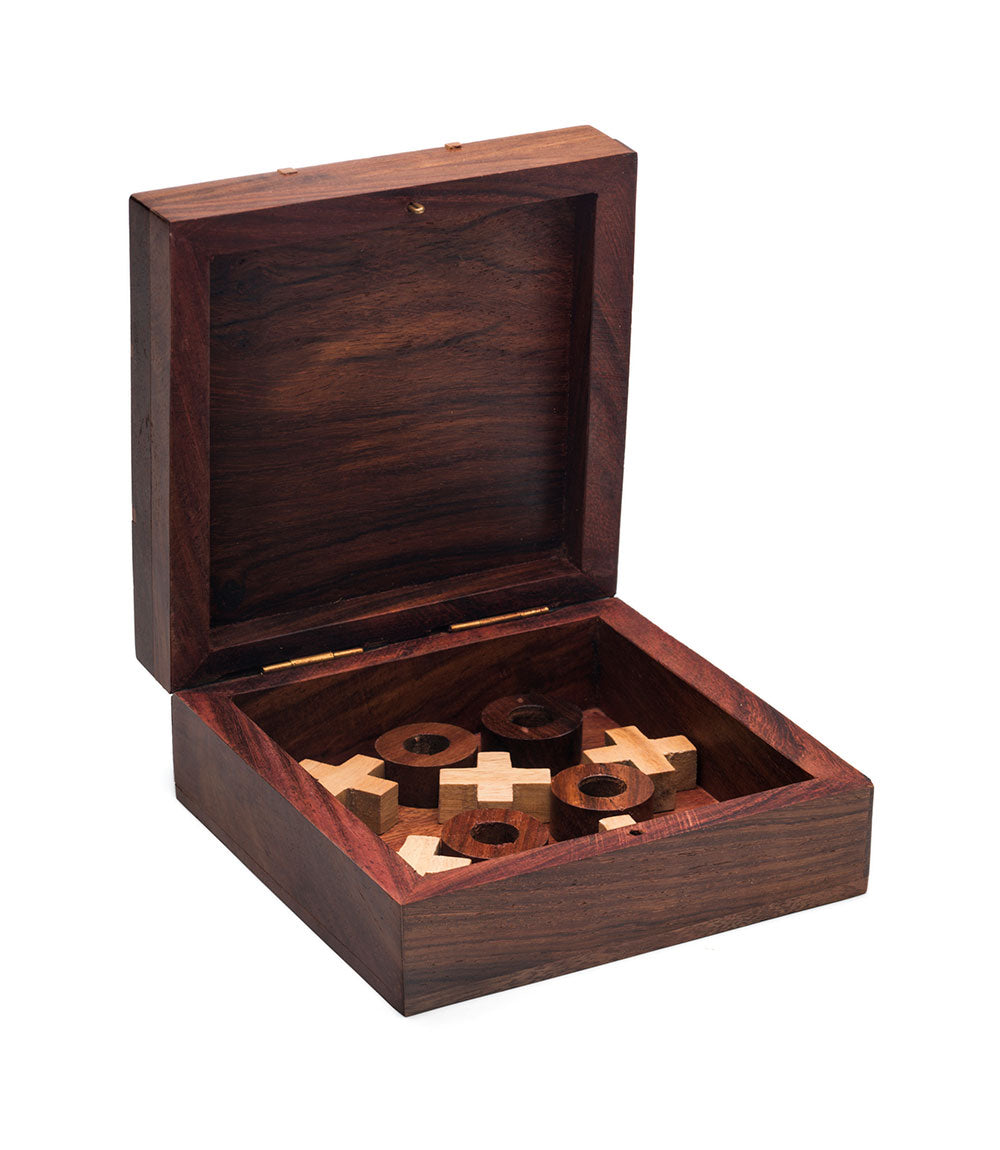 Wood tic-tac-toe travel game set in open carved wooden box with plus and ring pieces