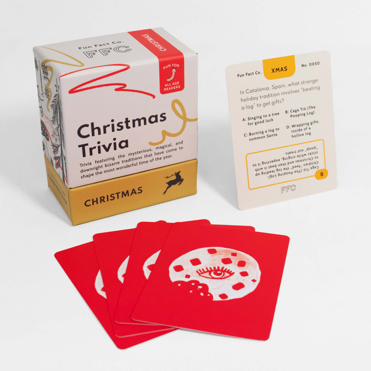 Christmas trivia card game box with trivia cards fanned out in red