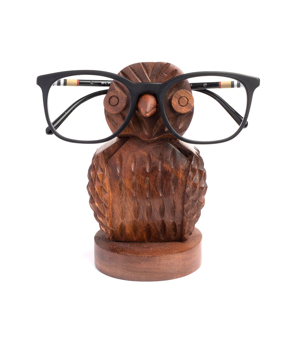 Wooden owl eyeglass holder stand with black eyeglasses, face-on view.