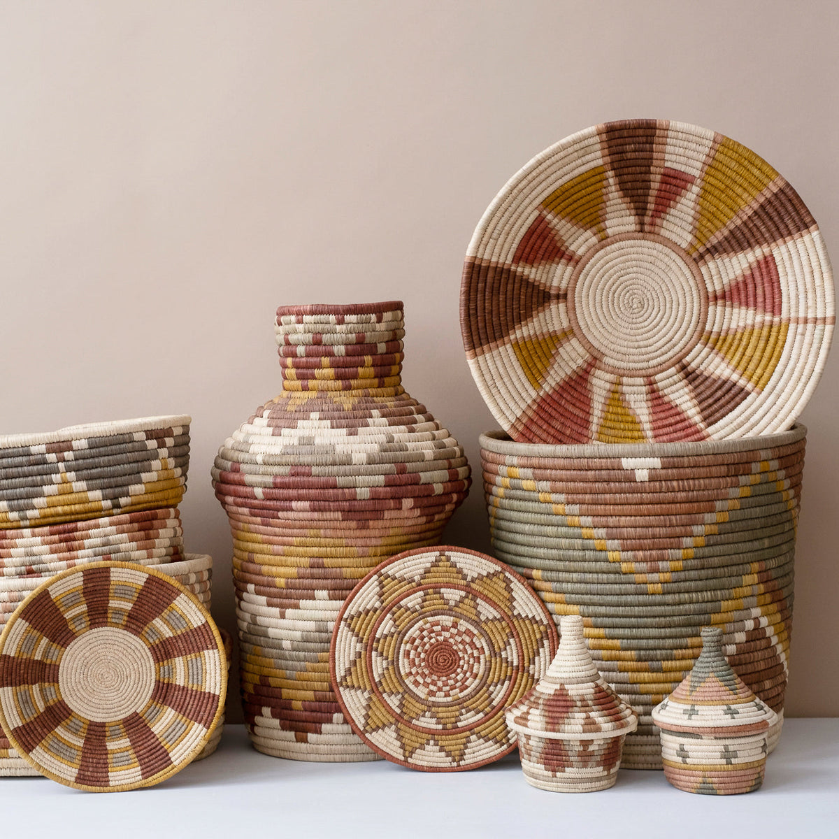 Woven coffee basket set with multiple lidded containers and sunburst coasters in earth tones