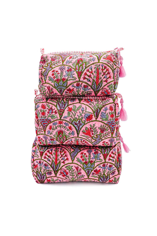 Toiletry bag with pink botanical arch print and tassel tie closures