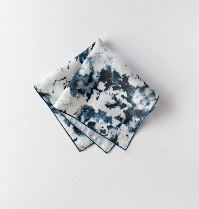 Marble-print napkin set with dark blue-gray splatter and gold trim edging