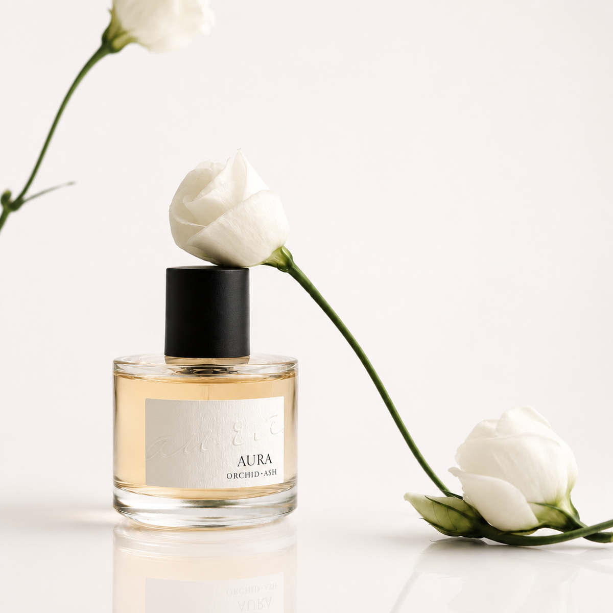 Clear glass perfume bottle with black cap with white flowers on both sides