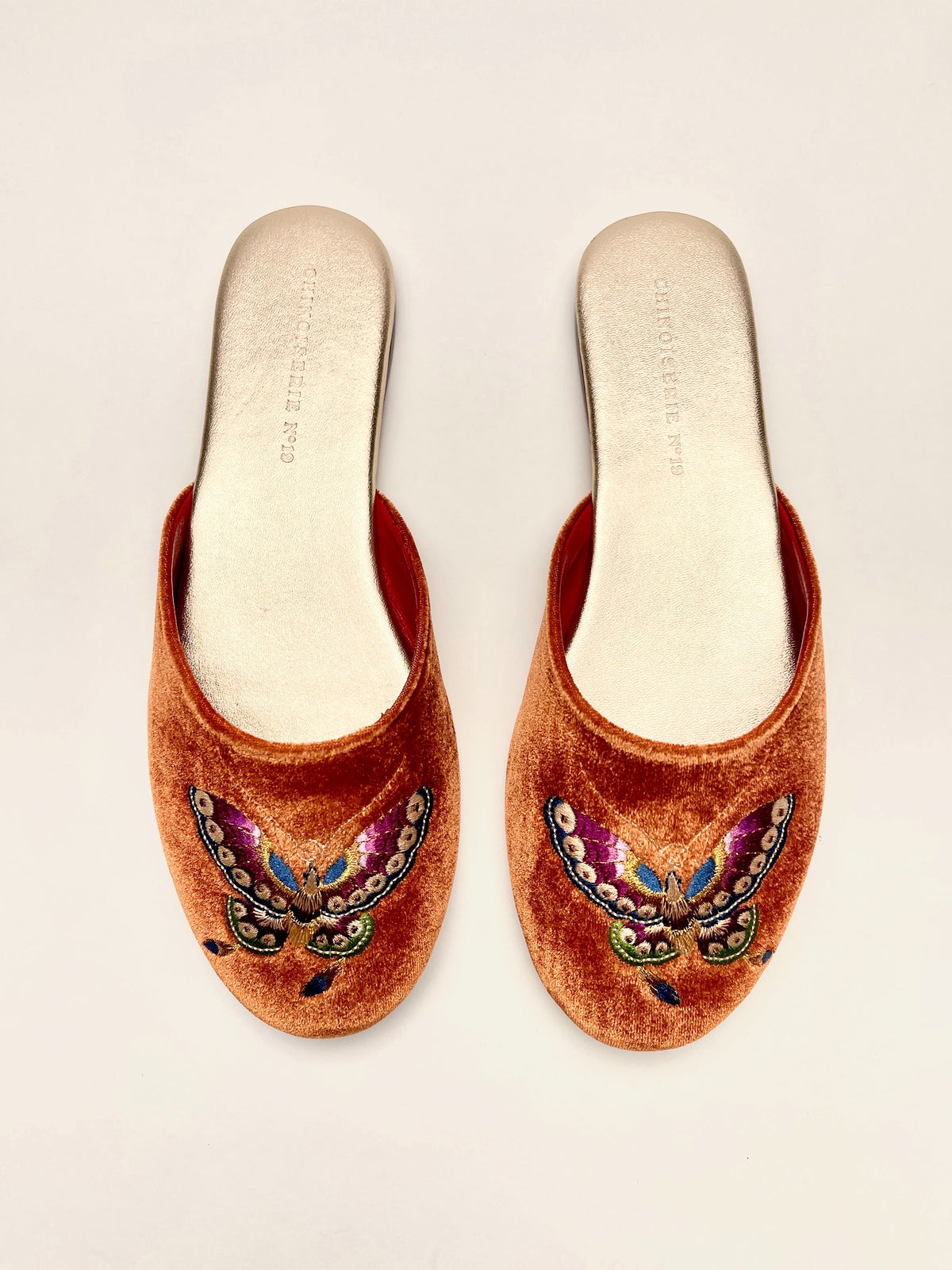 Burnt orange velvet mule slippers with colorful butterfly embroidery, slip-on style
