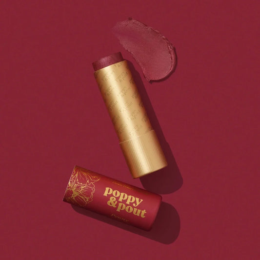 Lip tint tubes with gold caps, red shade product close-up