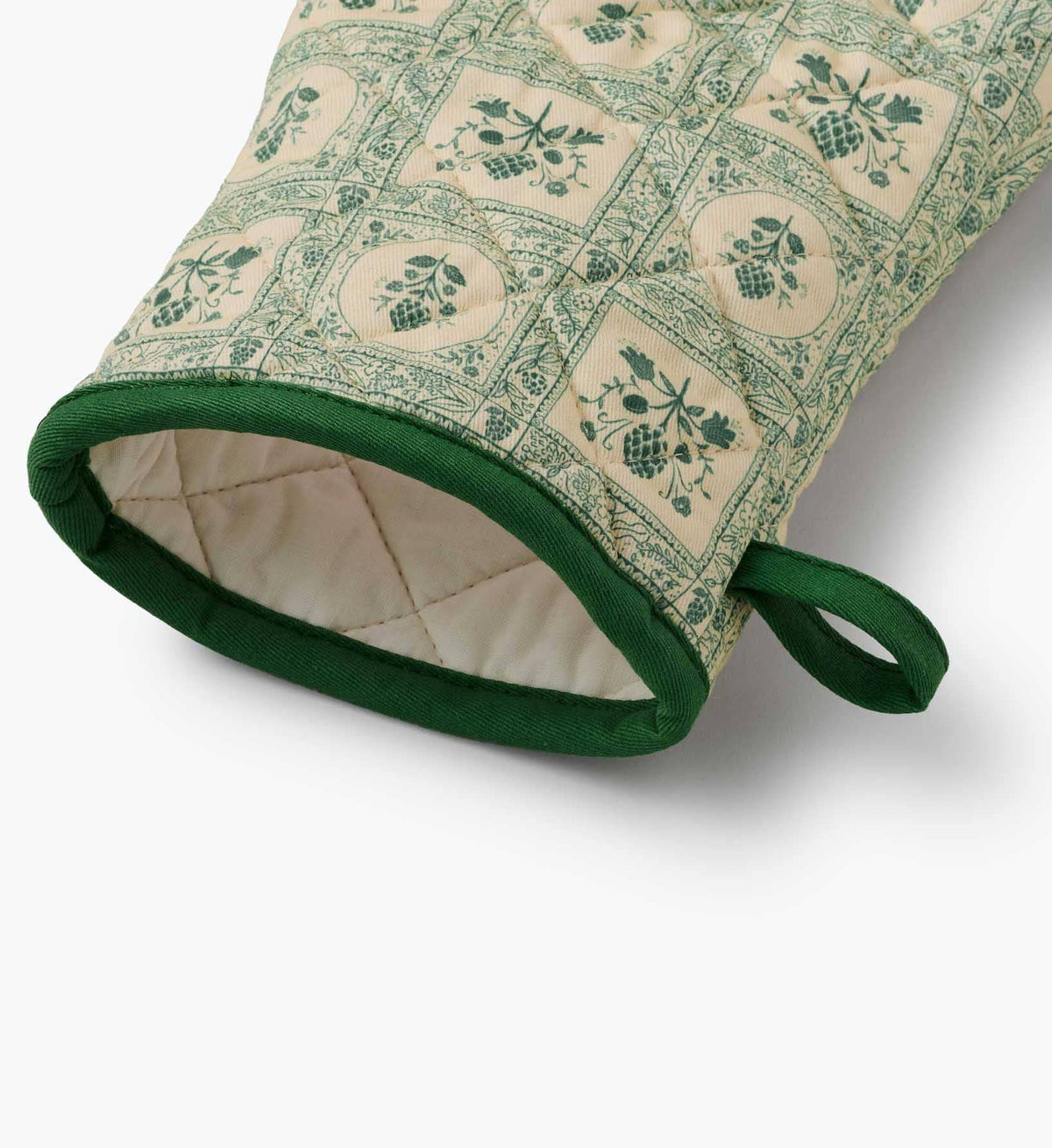 Rifle Paper Co. quilted oven mitt close-up, green cuff trim and beige inner lining