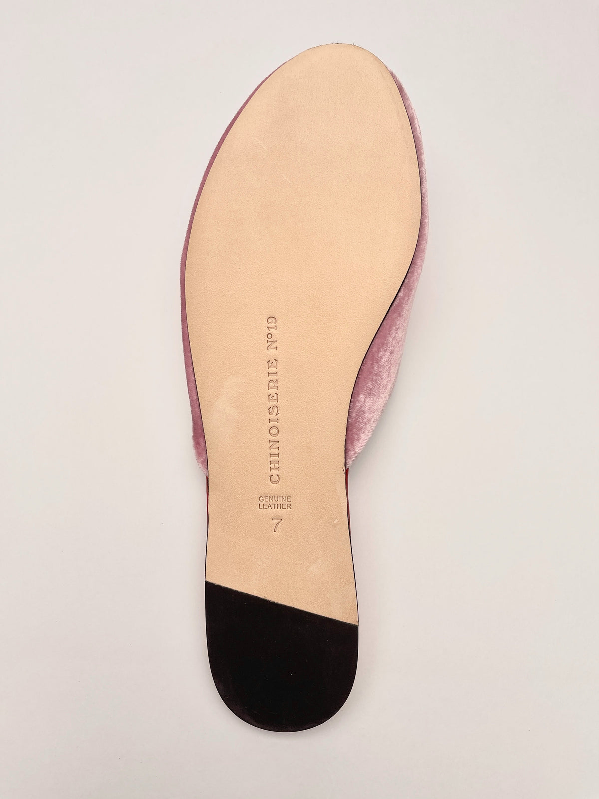 Lavender pink mule insole view with printed text, red sole edge