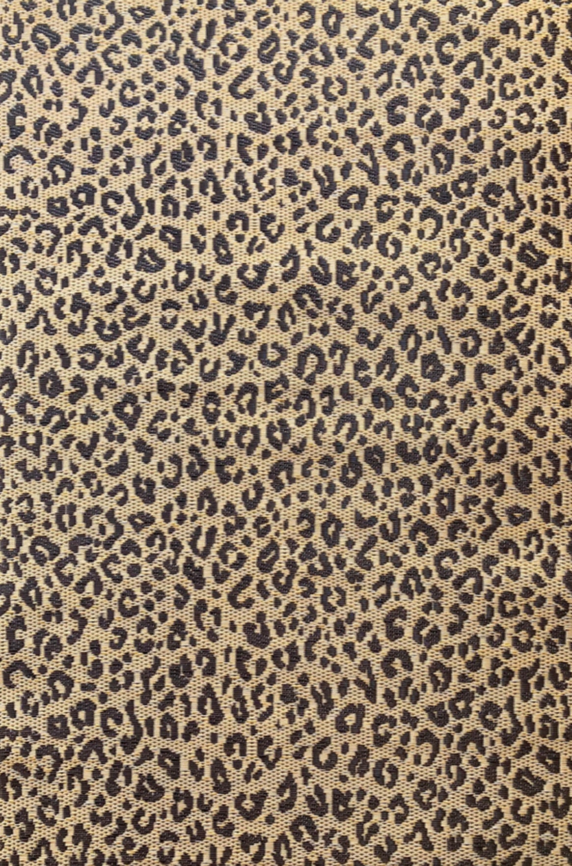 Leopard-print natural rug with small dark spots on a light beige background