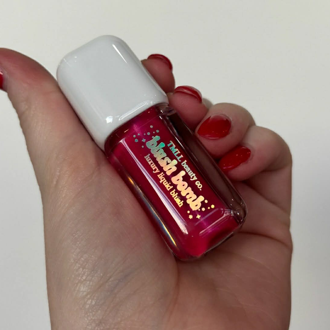 Liquid blush mini bottle with white cap in deep berry-magenta.