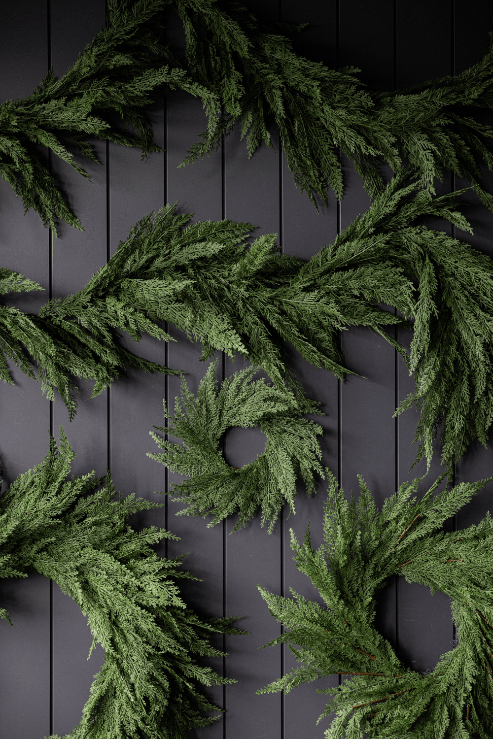 Green cypress leaf wreath with dense foliage and central circular opening