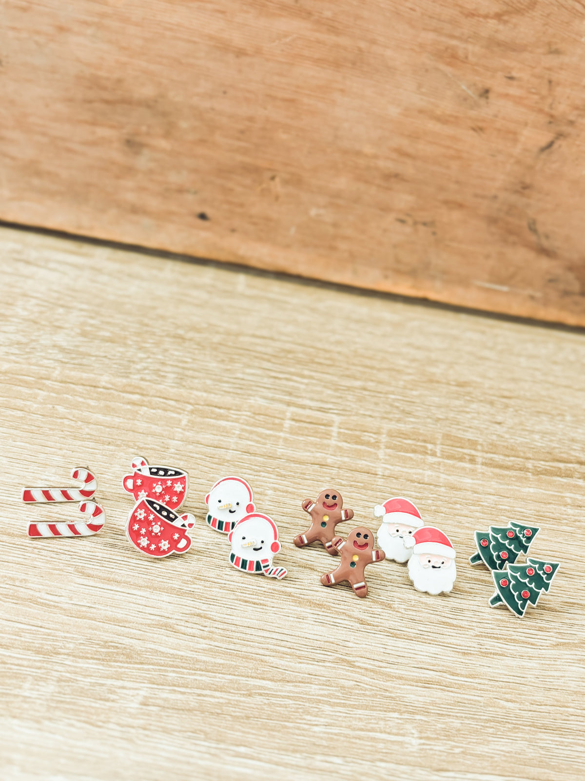 Christmas stud earrings with candy cane, red stocking, snowmen, gingerbread, Santa, and tree