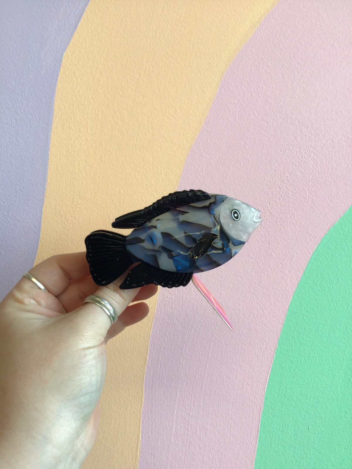 Blue fish hair claw with translucent scales and hinged comb teeth.