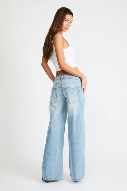 Light blue wide-leg low-rise jeans with back patch pockets and button fly