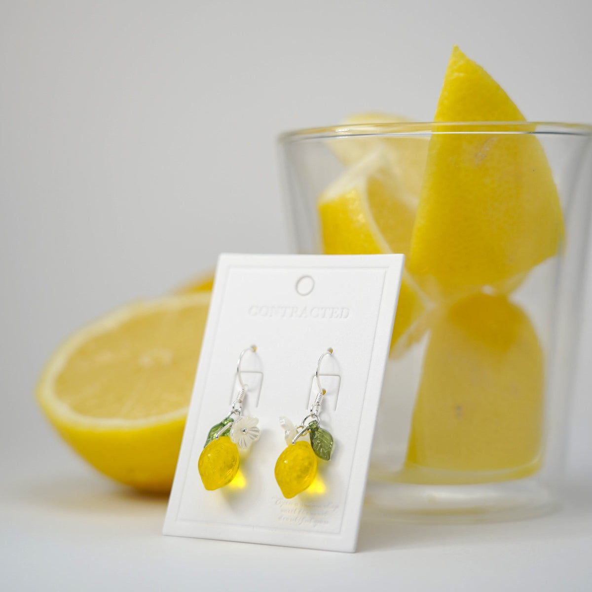 Handmade lemon fruit dangle earrings with silver hooks, yellow translucent lemon charms.