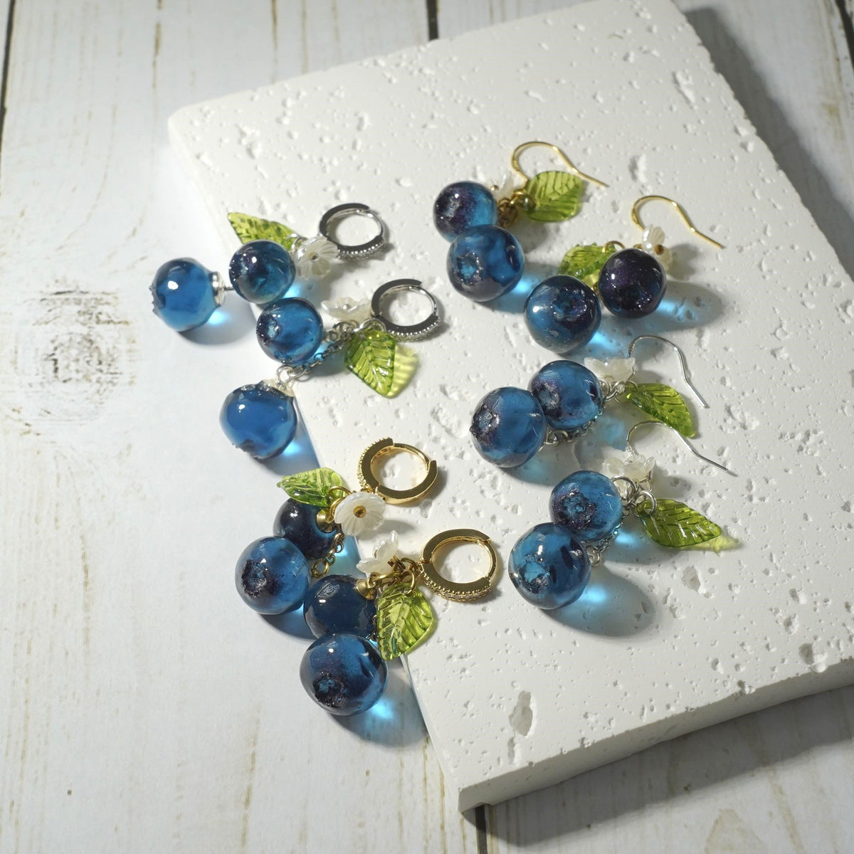 Blueberry cluster earring set with blue resin berries and green leaves, mixed gold and silver