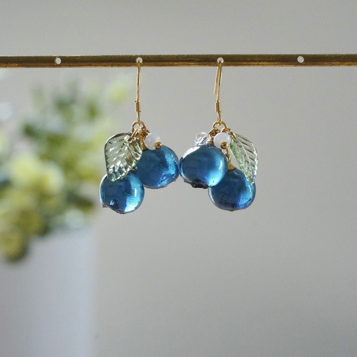 Blue resin berry cluster earrings with gold hooks and silver leaf charms