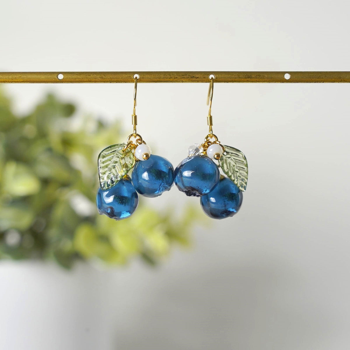 Blueberry resin cluster earrings with gold hooks, blue beads, green leaf charms