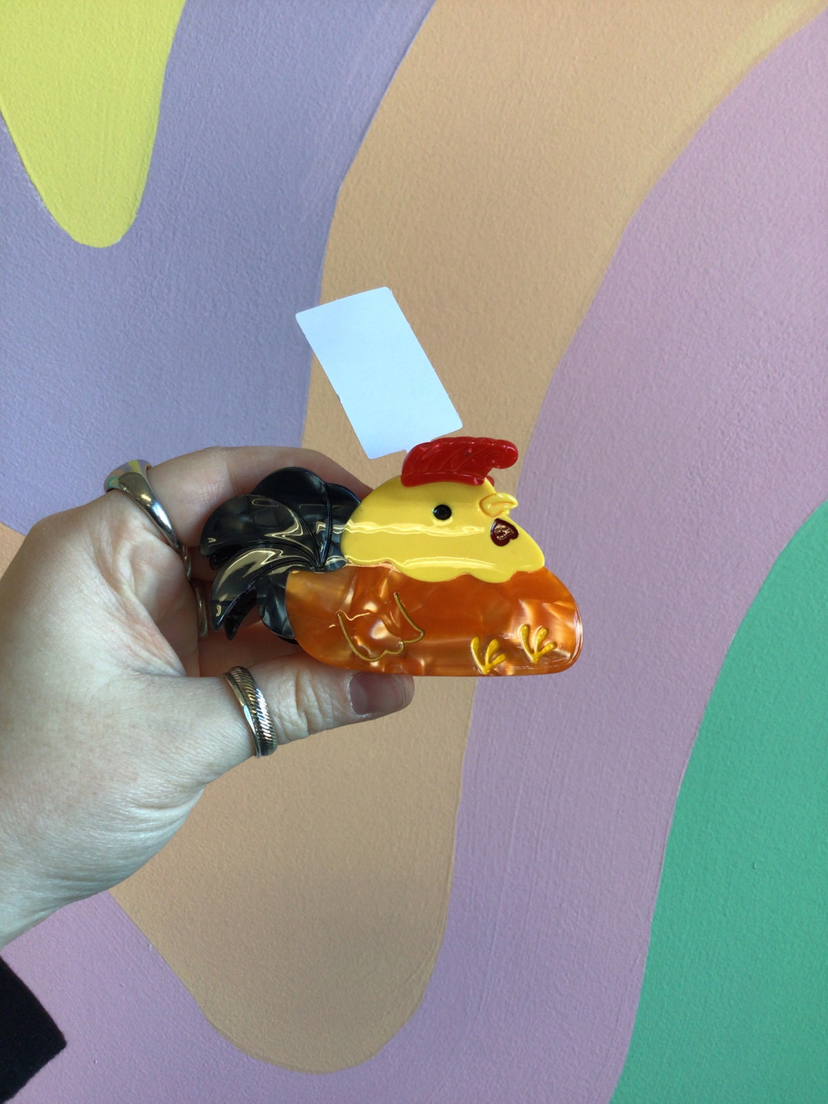 Yellow and amber animal hair claw with rooster face and glossy finish