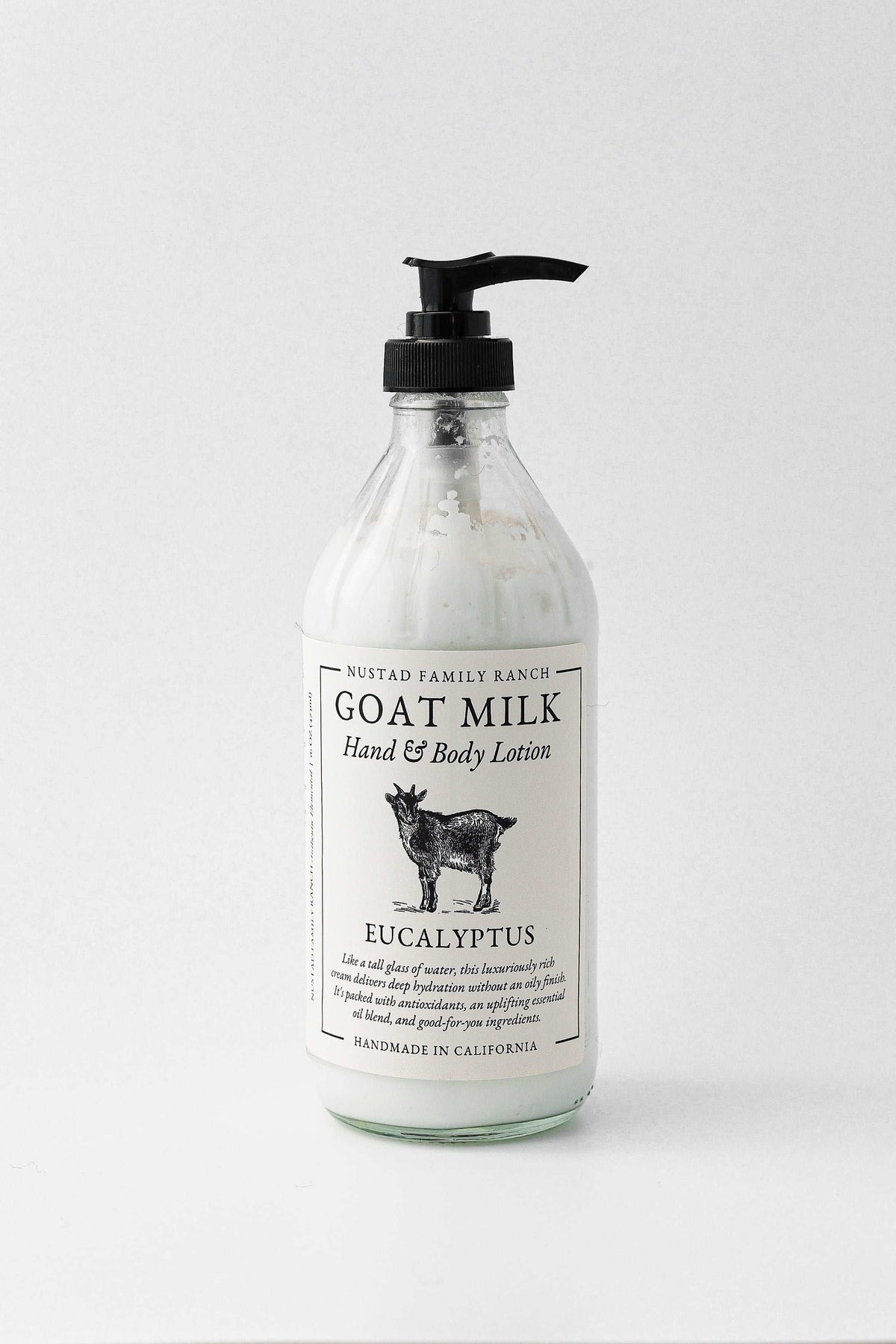 Goat milk body lotion bottle with eucalyptus scent and black pump